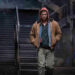 Glen Powell as Ben Richards walking and wearing a hoodie in The Running Man (2025)
