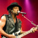 D'Angelo plays the guitar on stage.