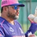 Siddhartha Lahiri, Rajasthan Royals coach, holding cricket balls and a water bottle during a training session.