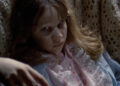 A possessed Regan lying down in The Exorcist