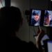 A person looks at dual vertical monitors during a scene of a film