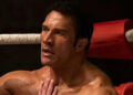 Mark Kerr sitting against a turnbuckle in The Smashing Machine
