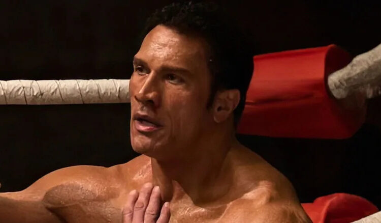 Mark Kerr sitting against a turnbuckle in The Smashing Machine