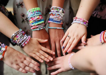 Taylor Swift fans show off friendship bracelets.