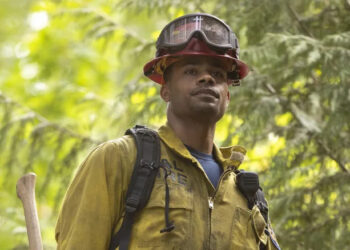 Jake in the woods with an axe in "Fire Country" (2021-present)