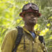 Jake in the woods with an axe in "Fire Country" (2021-present)