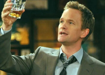 Barney holding up a scotch in How I Met Your Mother