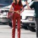 Kaia Gerber was spotted on Ryan Murphy's set wearing all chili flake fall red