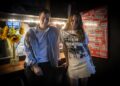 Max Pitegoff and Calla Henkel pose in front of a mirror in the greenroom.