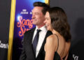 Hugh Jackman and Sutton Foster pose for photos at an event