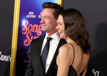 Hugh Jackman and Sutton Foster pose for photos at an event