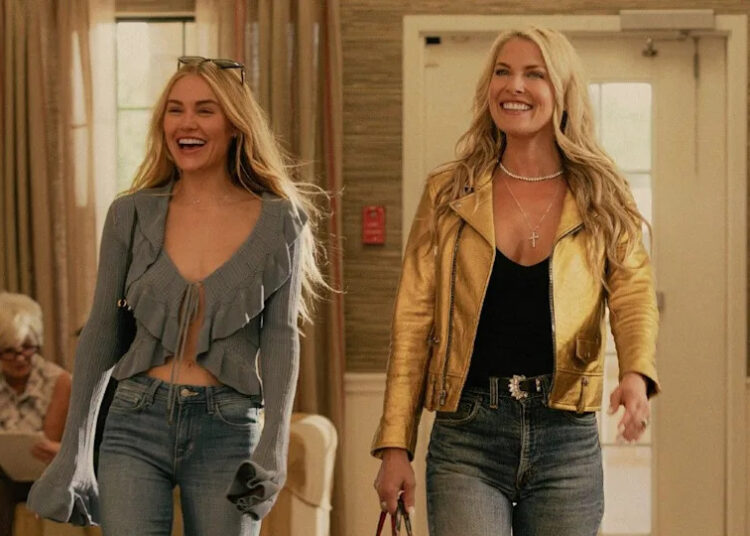 L to R Michelle Randolph as Ainsley Norris and Ali Larter as Angela Norris smiling and walking. .