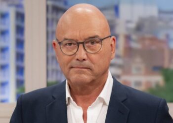 A close up of Gregg Wallace in a suit and wearing glasses with a serious expression