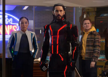 Ares (Jared Leto, center) gets an assist in the real world from ENCOM CEO Eve Kim (Greta Lee) and her assistant Seth (Arturo Castro) in "Tron: Ares."