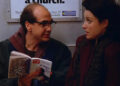 Ricky reading a TV Guide to Elaine on a subway on Seinfeld
