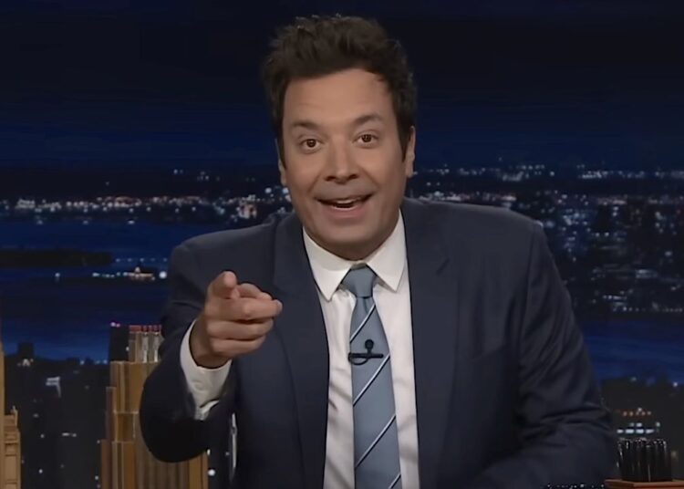 Jimmy Fallon smiling and pointing directly into the camera in The Tonight Show