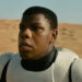 John Boyega as Finn wearing a Stormtrooper armor in the desert in Star Wars: The Force Awakens