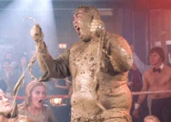 John Candy turns the table on his mud wrestling opponents as Dewey "Ox" Oxberger in Stripes