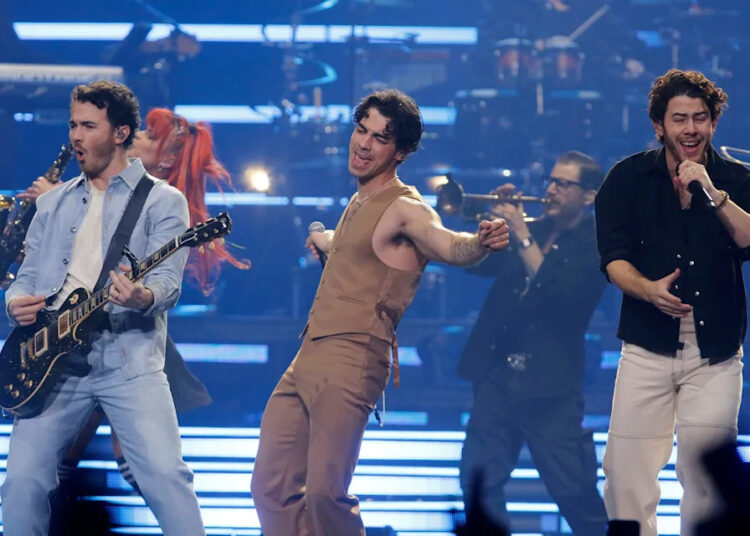 The Jonas Brothers -- Kevin (left to right), Joe and Nick -- perform in 2023 at the Prudential Center in Newark.