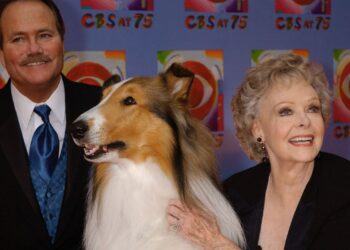 June Lockhart, right, who played the character of Ruth Martin, mother of Timmy Martin, played by Jon Provost, left, during the classic series "Lassie," poses for a photograph with Lassie, 9th generation, during arrivals at CBS's 75th anniversary celebration Sunday, Nov. 2, 2003, in New York. (AP Photo/Louis Lanzano, File)