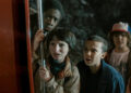 Lucas, Mike, Eleven, and Dustin looking worried in Stranger Things