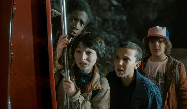 Lucas, Mike, Eleven, and Dustin looking worried in Stranger Things