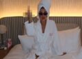 Kate Cassidy lying in bed, sticking up her middle finger toward the camera in a defiant gesture, shared on her Instagram.