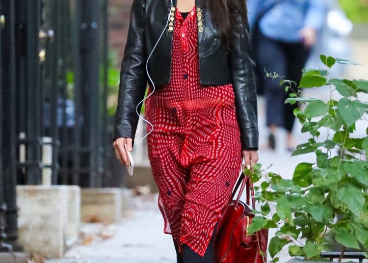 Katie Holmes was spotted in New York wearing tomato red ballet flats, a matching shirt dress, and black leggings