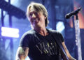 Keith Urban wearing a black shirt while on stage at CMA Fest in June 2025.