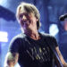 Keith Urban wearing a black shirt while on stage at CMA Fest in June 2025.