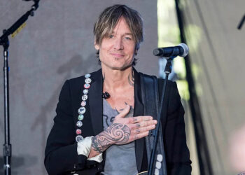 keith urban on stage with his hand over his heart