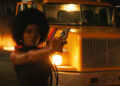 Keke Palmer as Alice aiming a pistol in Alice
