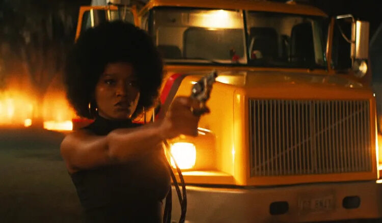 Keke Palmer as Alice aiming a pistol in Alice