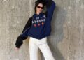 Kendall Jenner wears a track jacket, white pants, and black loafers