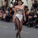 Jenner donned the sparkling silver, corset bodysuit with tasseled details and fabric that fell down behind her