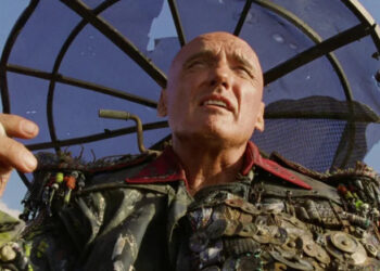 Dennis Hopper as The Deacon holding a cigarette in Waterworld