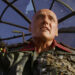 Dennis Hopper as The Deacon holding a cigarette in Waterworld