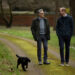 Prince William walking in a park with Eugene Levy and Orla the dog