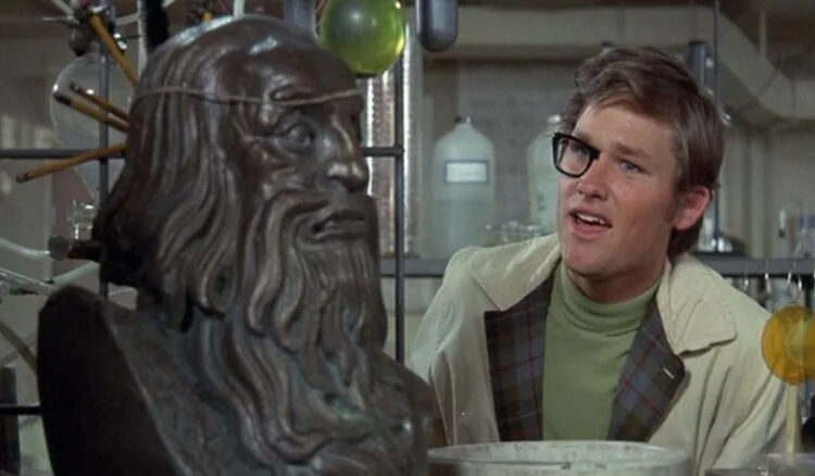 Dexter Riley with half-invisble glasses and a bust of an ancient man in Now You See Him, Now You Don't
