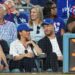 Prince Harry and Meghan Markle were sat in front of Sandy Koufax (L) and Magic Johnson (R)