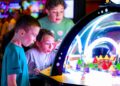 Children playing at an arcade inside Launch Entertainment.