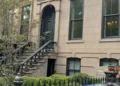 Exterior of Lily Allen and David Harbour's New York townhouse with classic brick facade and landscaped front.