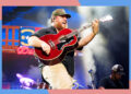 Country star Luke Combs rocks out on guitar in concert.