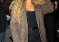 Mariah Carey poses in black shorts with plaid blazer as arriving at Watch What Happens Live With Andy Cohen in New York City