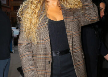 Mariah Carey poses in black shorts with plaid blazer as arriving at Watch What Happens Live With Andy Cohen in New York City
