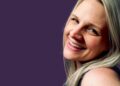 Lane smiles against a purple background
