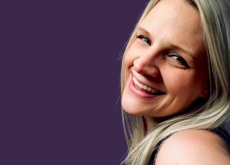 Lane smiles against a purple background