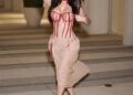 a person walking in a stylish outfit with a blended color scheme