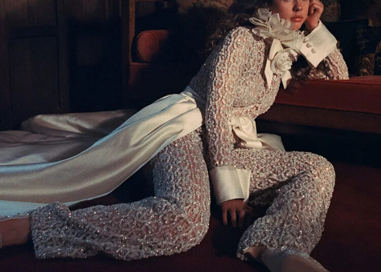 Mia Goth wears a white lace outfit in a shoot for Who What Wear.