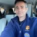 William Arnold, a music teacher, wears a blue fleece with "PTHS MUSIC" and an "I GOT THE COVID-19 VACCINE" sticker.